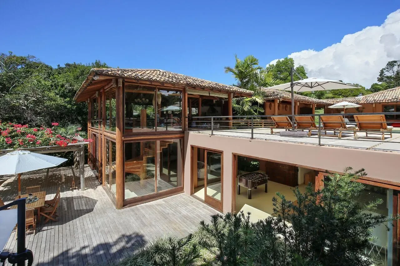 Casa 21 - fachada com deck de madeira e fechamento de vidro