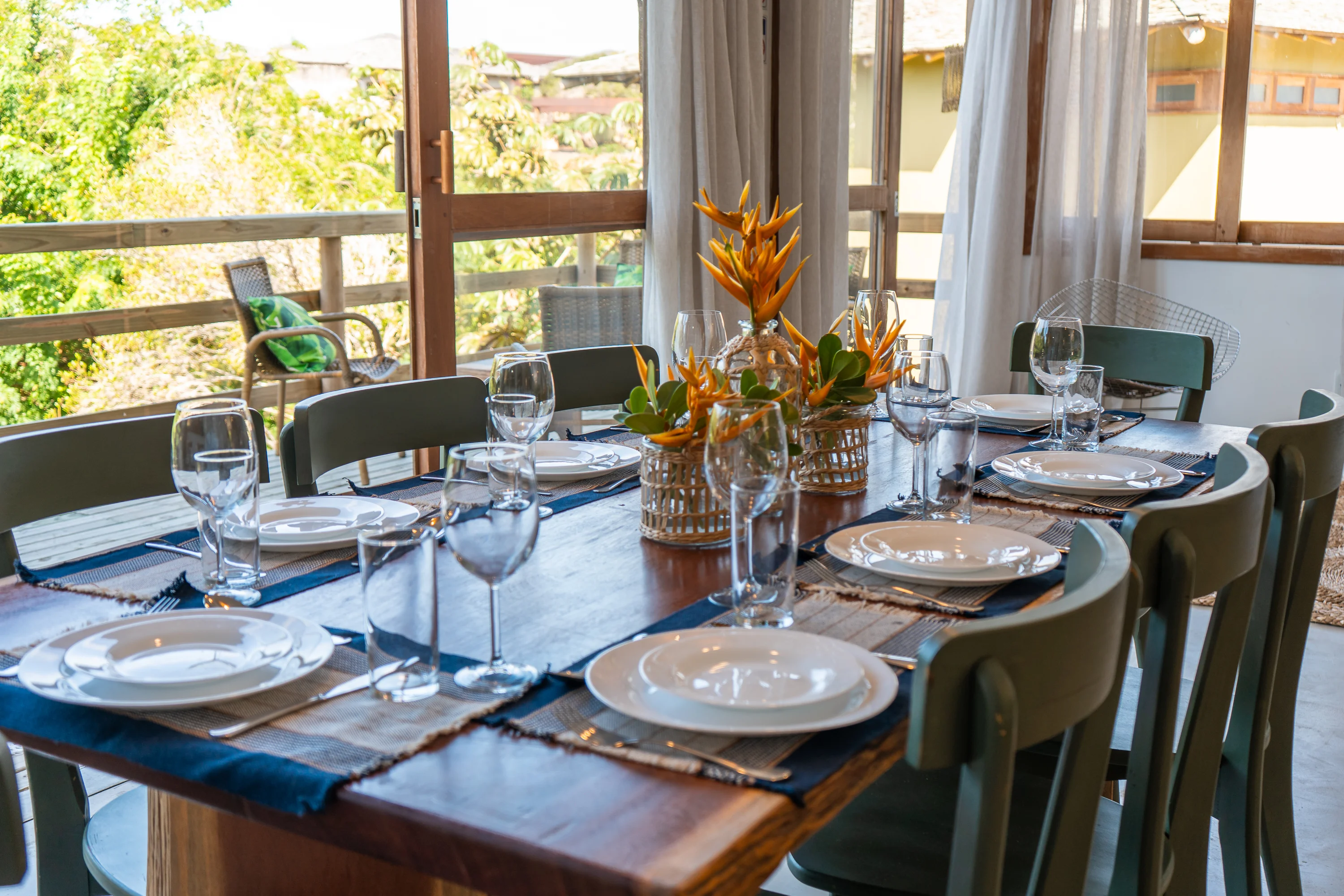 Casa 47 - gedeckter Esstisch mit Gläsern und tropischen Blumen